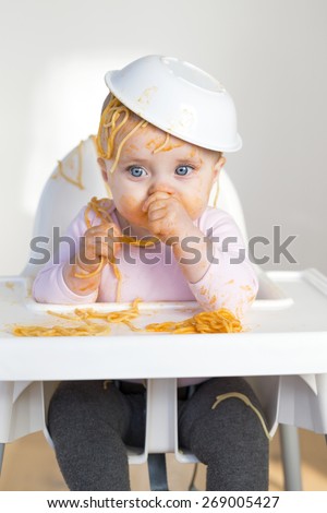 Little Girl Eating her dinner and making a mess