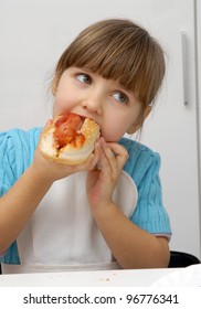 Little Girl Eating A Hot Dog.Kid Eating Hot Dog.