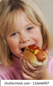 Little Girl Eating Hot Dog,Kid Eating Hot Dog.