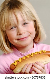 Little Girl Eating Hot Dog,Kid Eating Hot Dog.