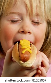 Little Girl Eating Hot Dog,Kid Eating Hot Dog.