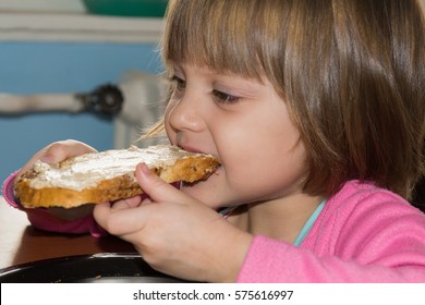 Little Girl Eating Loaf Of Bread With Pate 