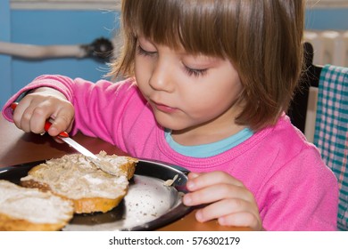 Little Girl Eating Loaf Of Bread With Pate 