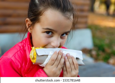 Little Girl Eating Messy Corn On The Cob