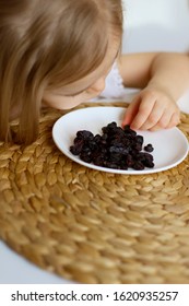 Little Girl Eating Raisins. Natural Vitamins