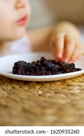 Little Girl Eating Raisins. Natural Vitamins