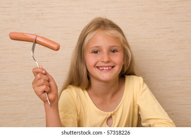 Little Girl Eating Sausage