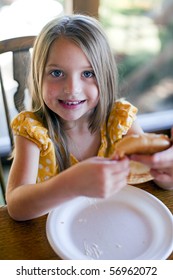 Little Girl Eating At The Table