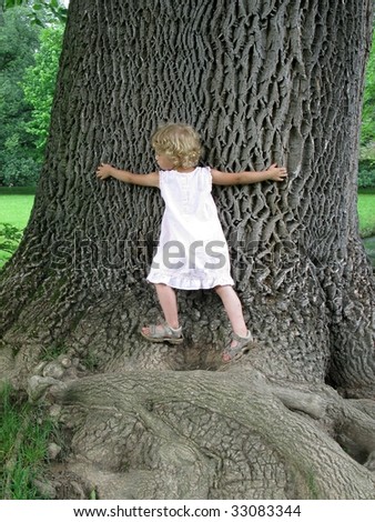 Little Girl embracing Huge Tree