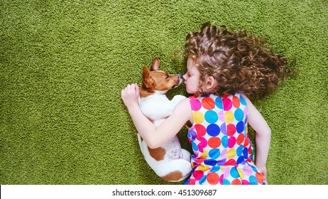 Little girl embracing puppy jack russell. High top view. - Powered by Shutterstock