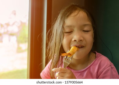 Little Girl Enjoy To Eating Spring Rolls With Shrimp