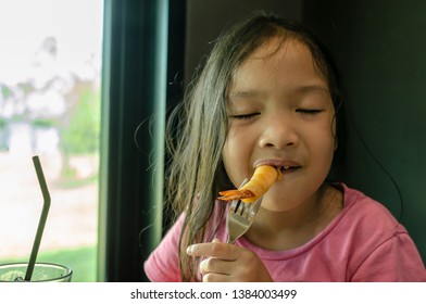 Little Girl Enjoy To Eating Spring Rolls With Shrimp