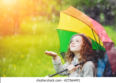 Little Girl Enjoy To Spring Rain. 