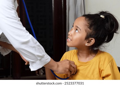 A little girl is examined by a doctor using a heart monitor. This is done to find out about the child's health and provide guidance. SHOTLISThealth - Powered by Shutterstock