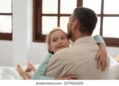 A little girl expresses his feelings for his father. By embracing as soon as you wake up in the beginning of the day - Powered by Shutterstock