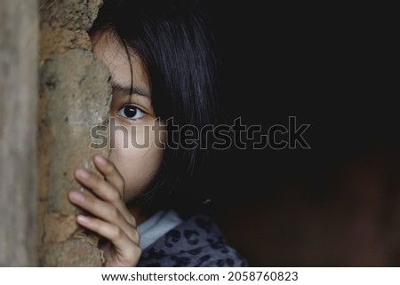 Little girl with eye sad and hopeless. Human trafficking and fear child concept. 