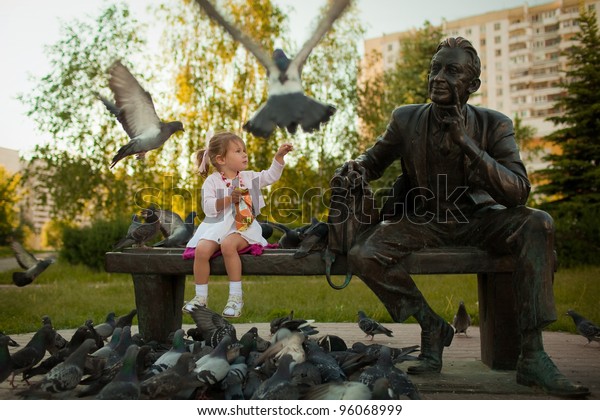 Little Girl Feeding Pigeons Park Near Stock Photo Edit Now 96068999