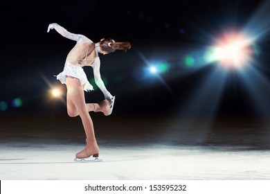 Little girl figure skating at sports arena - Shutterstock ID 153595232