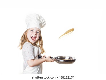 A Little Girl Flipping A Pancake
