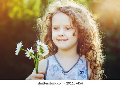 Little Girl With A Flower In Her Hand. Mothers Day Concept. Background Toned In Instagram Filter.