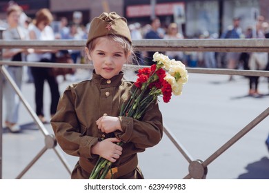 Little Girl With Flowers On The Holiday Of May 9, The Day Of Victory In Russia