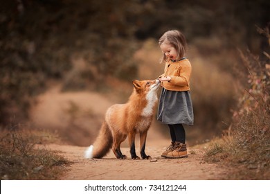 a little girl with a Fox in autumn forest