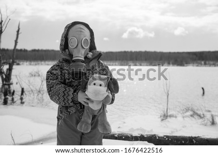 a little girl in a gas mask