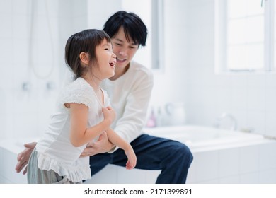 Little Girl Getting Dressed With Daddy