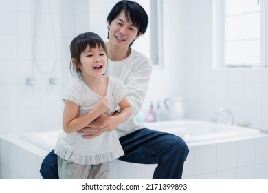 Little Girl Getting Dressed With Daddy