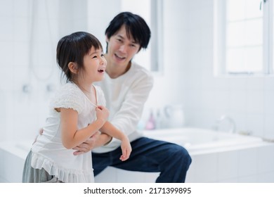 Little Girl Getting Dressed With Daddy