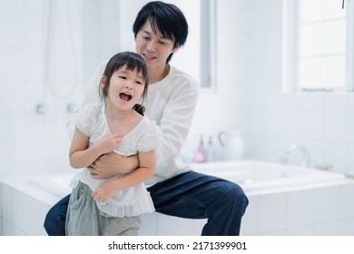 Little Girl Getting Dressed With Daddy