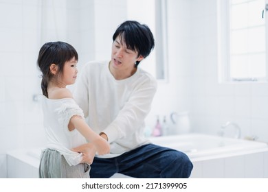 Little Girl Getting Dressed With Daddy