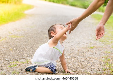 Little Girl Gives Hand To Her Mother. MOM Helps Baby Stand Up