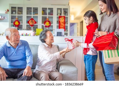 Little Girl Giving Gift To  Grandparent  For Chinese New Year