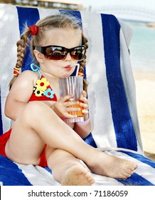 Little Girl In Glasses And Red Bikini Drink Orange Juice.