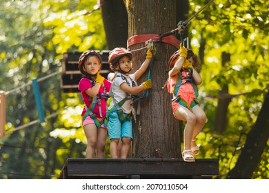 The little girl goes down the zipline in the park - Powered by Shutterstock