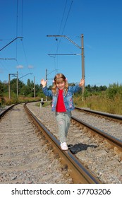 The little girl going with a backpack on railway rails - Shutterstock ID 37703206