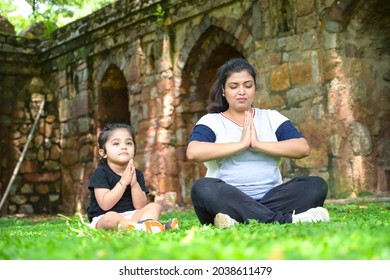 Little Girl Is Going Yoga With Her Yoga Teacher In Park