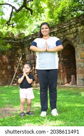 Little Girl Is Going Yoga With Her Yoga Teacher In Park