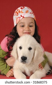 Little Girl With A Golden Retriever Puppy