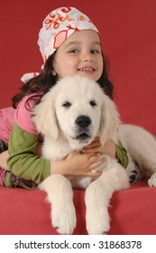 Little Girl With A Golden Retriever Puppy