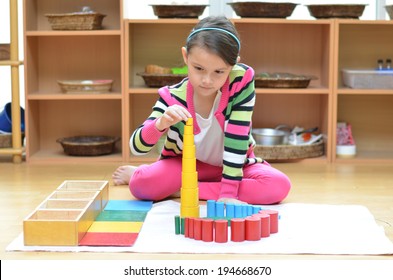 Little Girl Hand Building Tower Made Of Montessori Educational Materials