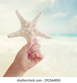 Little girl hand holding starfish
