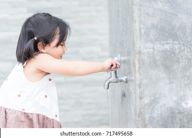 Little Girl Hand Shut The Faucet.water Saving Concept.