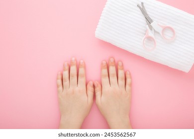 Little girl hands, scissors and white soft towel on light pink table background. Pastel color. Closeup. Point of view shot. Baby nail cutting. - Powered by Shutterstock