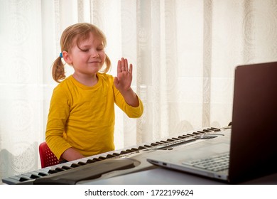 Little Girl Has Online Lesson With Teacher On Playing The Piano