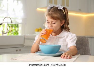 Little Girl Having Breakfast In Kitchen. Getting Ready For School