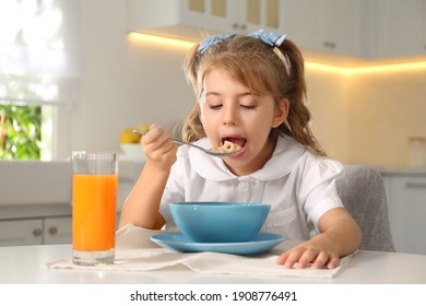 Little Girl Having Breakfast In Kitchen. Getting Ready For School