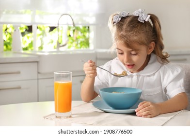 Little Girl Having Breakfast In Kitchen. Getting Ready For School