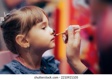 
Little Girl Having a Face Paint Moment at her Birthday Party. Cute, adorable toddler kid having fun with creative activity
 - Powered by Shutterstock